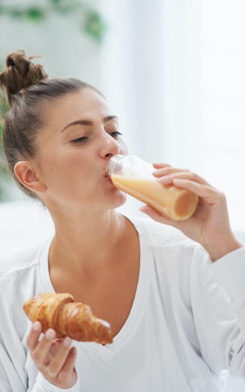 young-woman-on-bed-with-food-catering-box.jpg